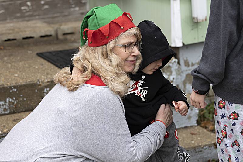 Joy Colberg gets a hug from Dylan Jablonski, 3, after the Rock Falls Police Department delivered gifts Friday, Dec. 22, 2023.