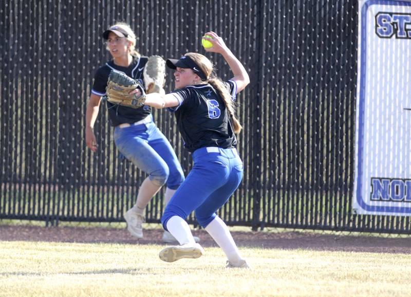 St. Charles North’s Ivy Gleeson throws the ball from right field as teammate Leigh VandeHei looks on during a Class 4A St. Charles North Sectional final against Lake Park on Friday, June 2, 2023.