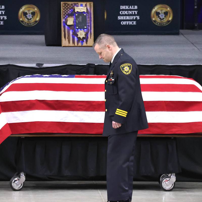 DeKalb County Sheriff Andy Sullivan bows his head as he approaches the flag-draped casket of colleague Deputy Christina Musil Thursday, April 4, 2024, during her visitation and funeral in the Convocation Center at Northern Illinois University. Musil, 35, was killed March 28 while on duty after a truck rear-ended her police vehicle in Waterman.