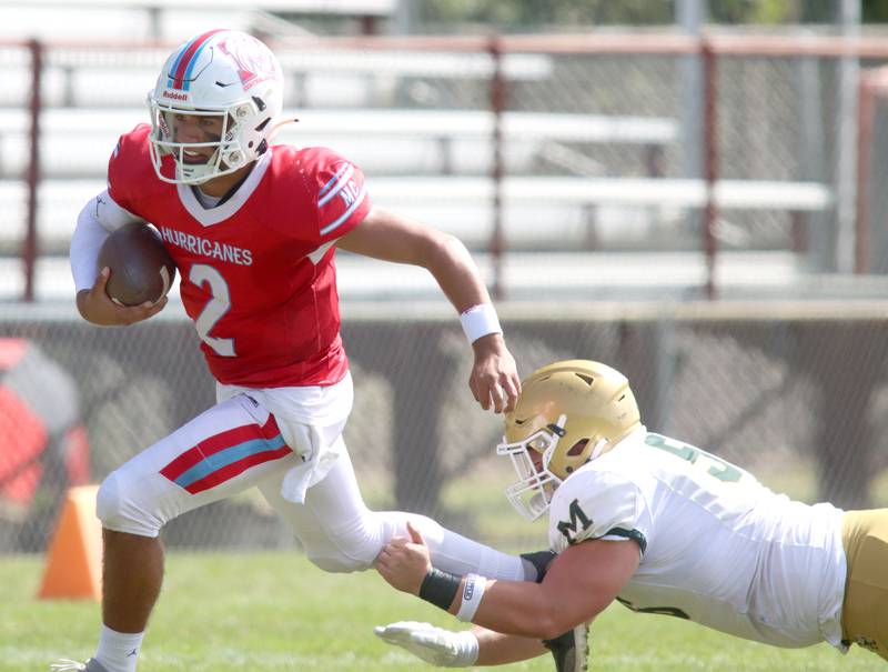 Marian Central’s Picasso Ruiz scrambles with the ball against Bishop McNamara in varsity football action on Saturday, Sept. 14, 2024, at George Harding Field on the campus of Marian Central High School in Woodstock.