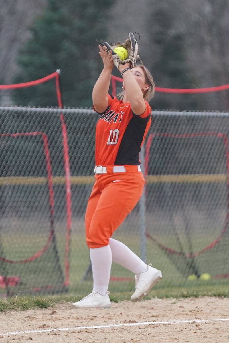 St. Charles East's Katie Morgan (10) catches a infield popup for an out against Oswego East during a softball game at Oswego East High School on Wednesday, March 13, 2024.