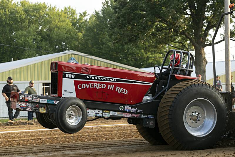 John Anderson digs in at the Badger State Tractor Pullers event Wednesday, August 9, 2023 at the Carroll County fair.