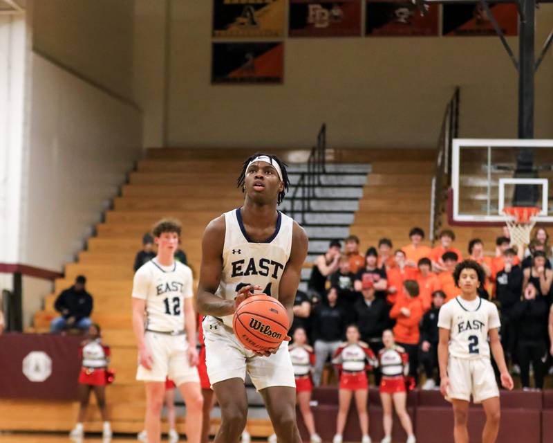 Oswego East's Mekhi Lowery (24) shoots a technical during Class 4A Lockport Regional final game between West Aurora at Oswego East.  Feb 24, 2023.