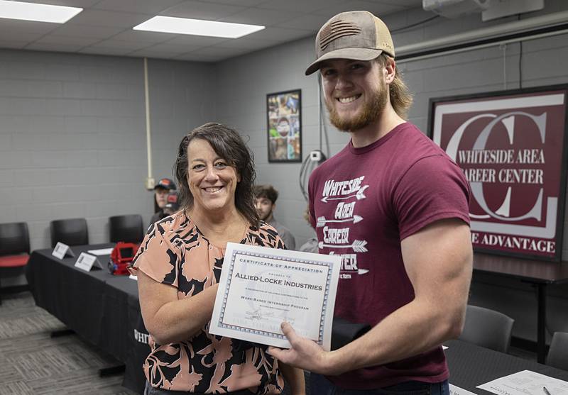 Amy Garriott of Allied-Locke congratulates Luke Corcoran of Amboy High School on his new position at the manufacturing company Friday, May 17, 2024.