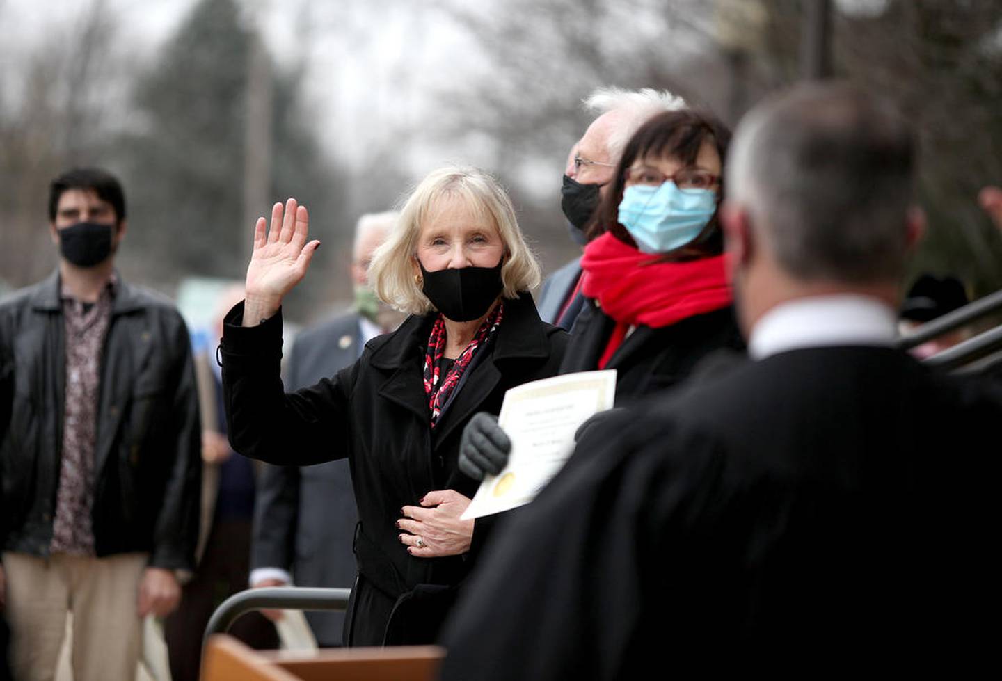 Kane County Board Chairman Corinne Pierog (center) is sworn in on the steps of the Kane County Government Center's Building A by Chief Judge Clint Hull during an outdoor ceremony on Dec. 8.