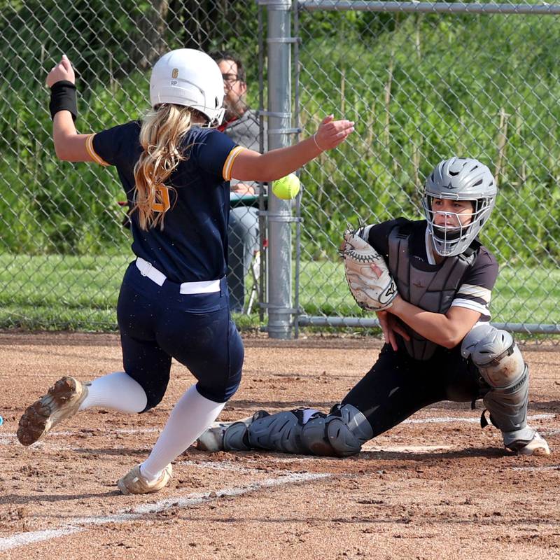 Sycamore's Kairi Lantz tries to catch the throw from the outfield as Sterling's Olivia Melcher scores on a close play during their game Tuesday, May 14, 2024, at Sycamore High School.