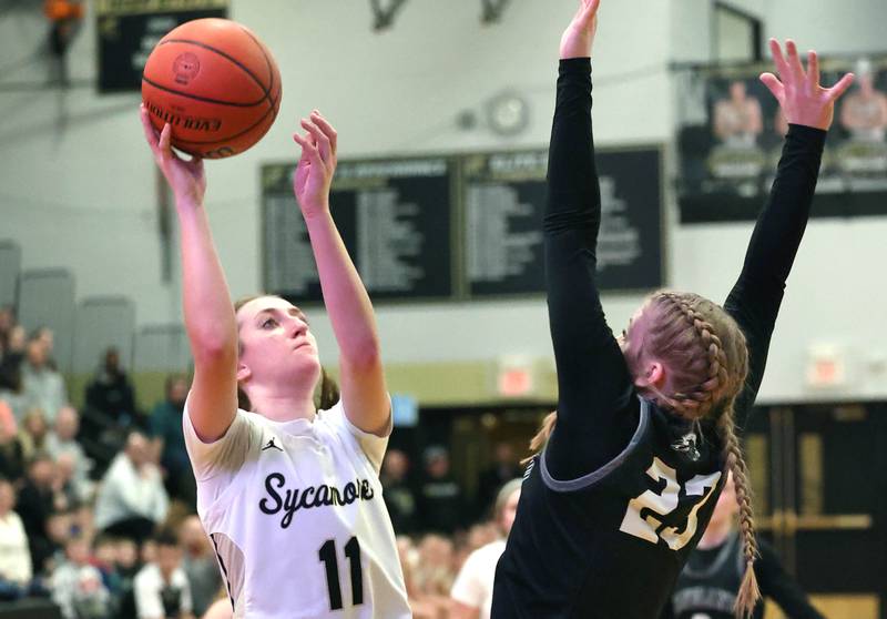 Sycamore's Megan Brannon shoots over Kaneland's Kendra Brown during their Class 3A sectional semifinal Tuesday, Feb. 20, 2024, at Sycamore High School.