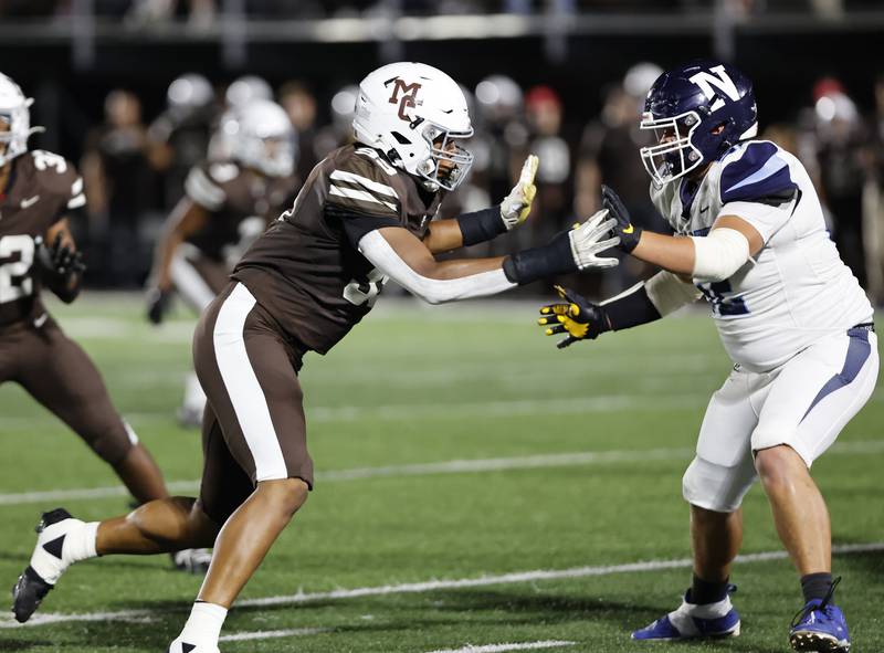 Mt. Carmel's Braeden Jones (99) rushes the Nazareth offensive line during the varsity football game between Nazareth Academy and Mt. Carmel high school on Friday, Sep. 13, 2024 in Chicago.