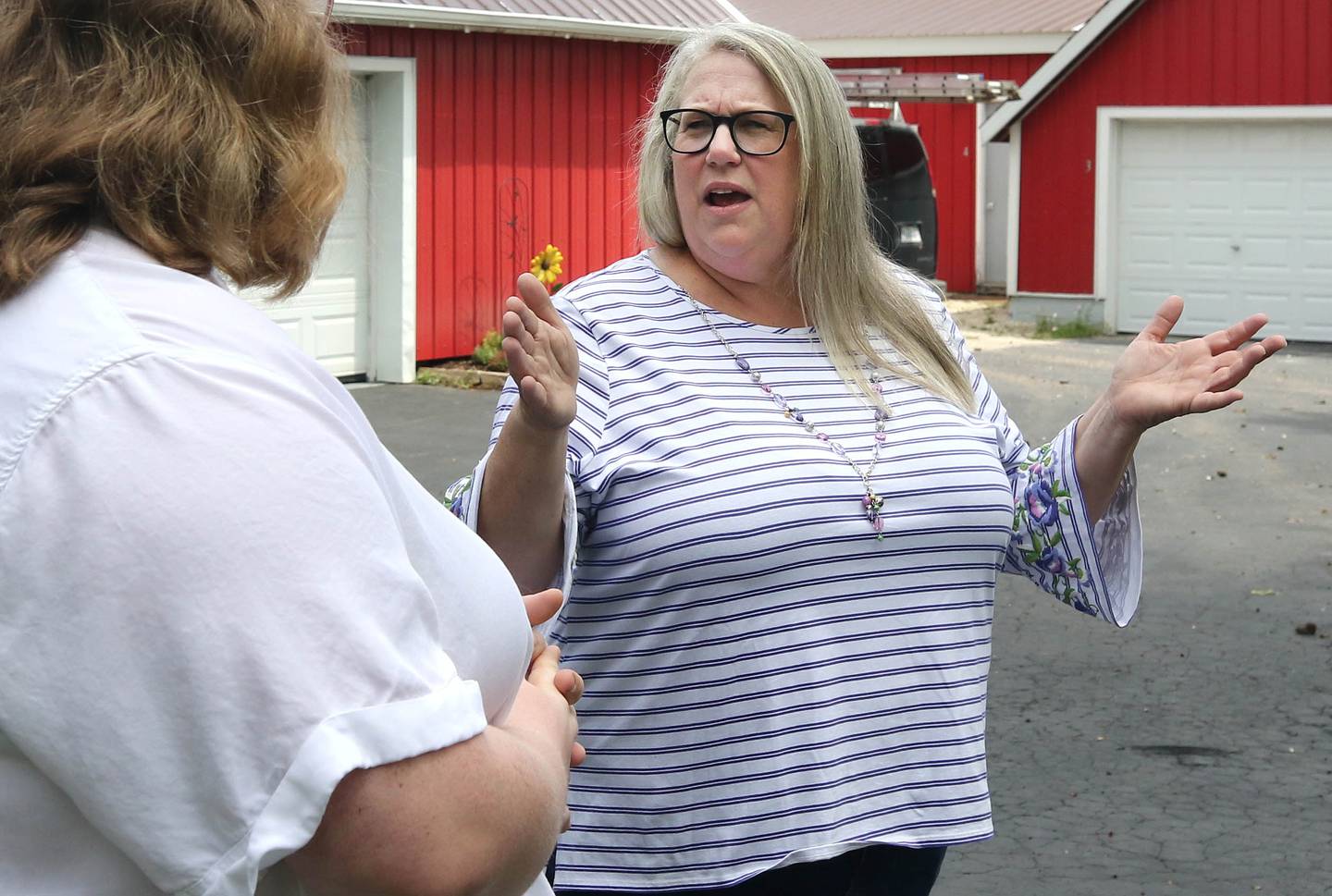 Tammy McMahan, (right) founder and executive director of the Ruth Project, along with her daughter Ashley, storehouse manager with the group, talk Thursday, July 13, 2023, at the organization’s 33-acre farm in Sycamore. The Ruth Project is a group based in Elgin that provides support for foster parents and children.