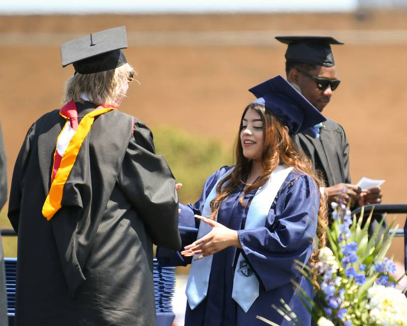 A Downers Grove South Senior is all smiles as she receives her diploma on Sunday May 19, 2024, at Downers Grove South High School.