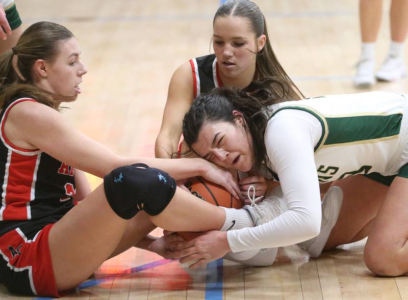 St. Bede's Ali Bosnich forces a jump ball with Amboy's Maeve Larson and teammate Elly Jones during the Class 1A Regional semifinal game on Friday, Feb. 16, 2024 at Marquette High School.