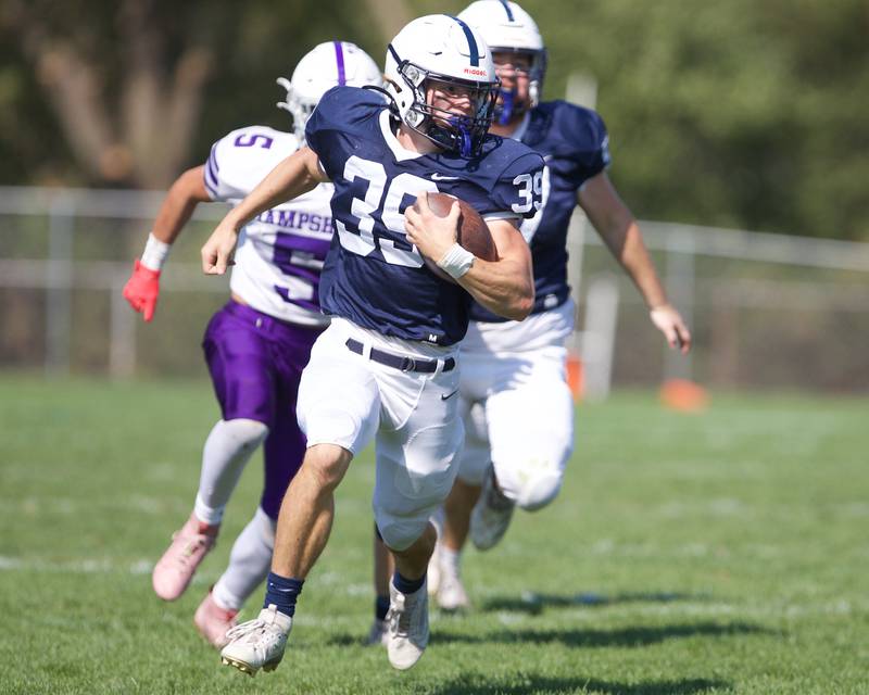 Cary Grove's Holden Boone carries the ball for a gain against Hampshire on Saturday Oct. 5,2024 in Cary.