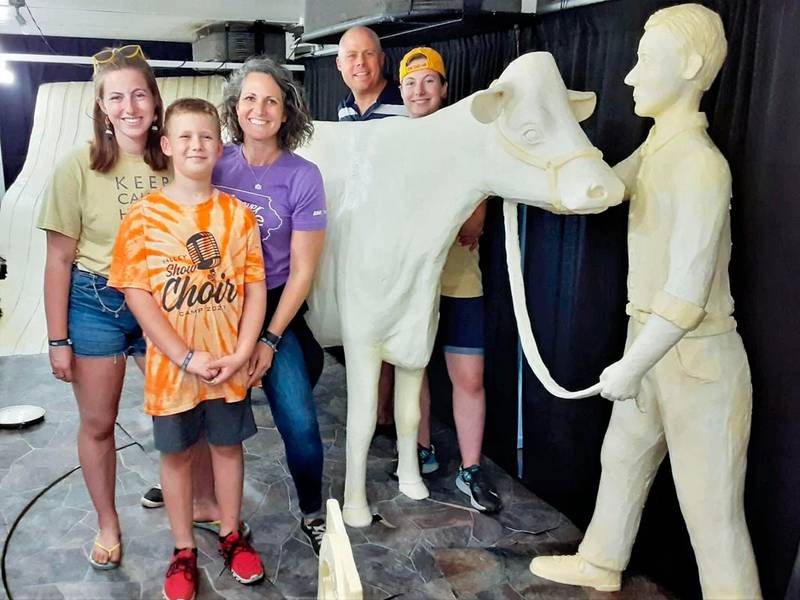 The Pratt family (from left), Hannah, Dean, Sarah, Andy and Grace, pose with a past state fair butter cow sculpture.