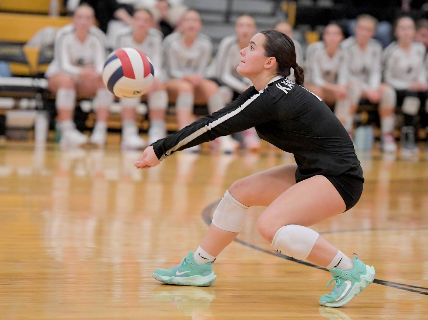 Kaneland's Mia Vassallo (4) returns a serve during a game at Sycamore on Tuesday, Sept. 26, 2023.