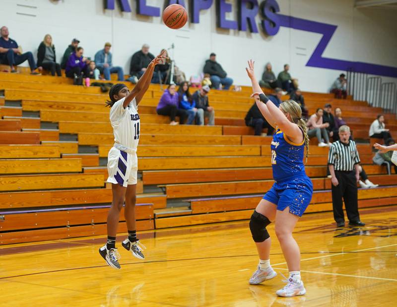 Plano's Luniah Gilford (14) shoots the ball against Johnsburg's Kaylee Fouke (12) during a basketball game at Plano High School on Tuesday, Jan 30, 2024.