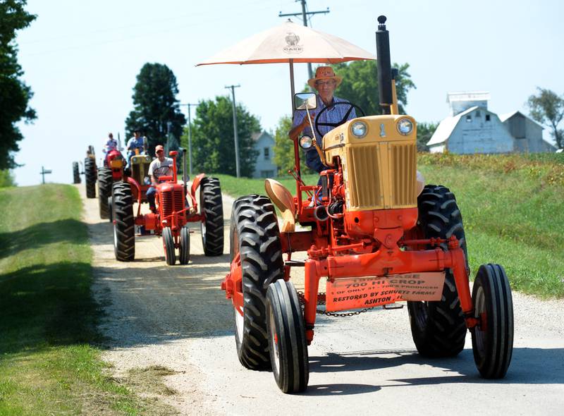 Remmer Schuetz, 88, of Ashton drives his 1958 Case 700 H tractor down a hill on Hoosier Road during the Living History Antique Equipment Association's tractor drive on Saturday. About 40 tractors took part in the ride that started at the association's show grounds in Franklin Grove and traveled to Oregon and back.