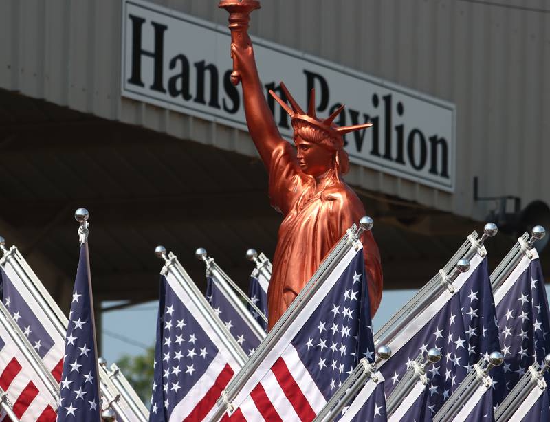 Flags and a Statue of Liberty clone are featured as part of the McHenry County Fair in Woodstock on Tuesday.