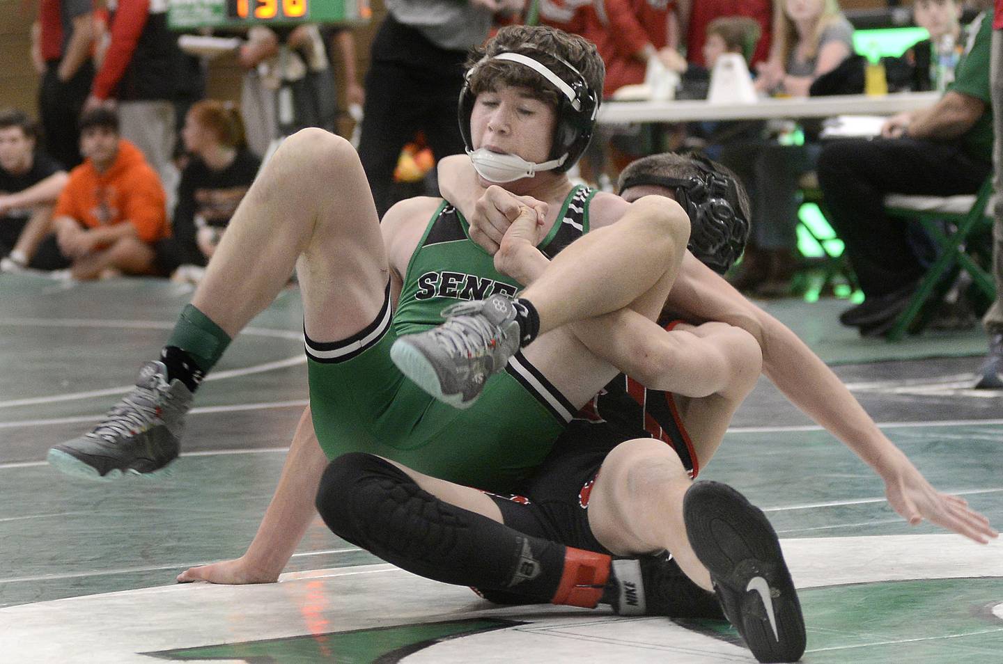 Seneca’s Nick Grant looks to escape a hold by Amboy’s Levi Near in the 132 weight class championship match on Saturday, Dec. 3, 2022 at Seneca.