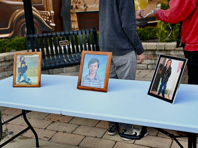 Photos lined up of  7-year-old  Dalton Mesarchik at the vigil at Heritage Park in Streator on Saturday March 30.