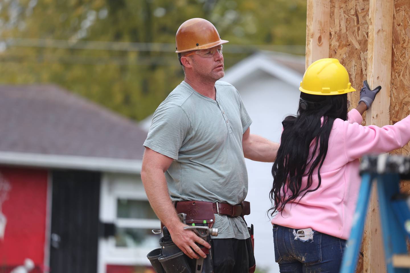 Adam Cheney, of CITCO, supervises as a wall frame is put in place of a home being built by Habitat for Humanity on Wednesday, Oct. 25, 2023 in Lockport.