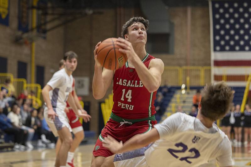 LaSalle-Peru’s Brendan Bourdeau fouls Dixon’s Bryce Feit Wednesday, Feb. 21, 2024 at the Sterling class 3A basketball regional.