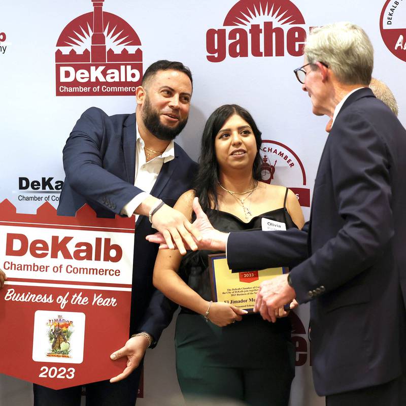 Christopher Cardenas and Olivia Pacheco from El Jimador Mexican Grill accept congratulations from DeKalb City Manager Bill Nicklas after being named as the 2023 Business of the Year Thursday, Feb. 8, 2024, during the DeKalb Chamber of Commerce’s Annual Celebration Dinner in the Barsema Alumni and Visitors Center at Northern Illinois University.