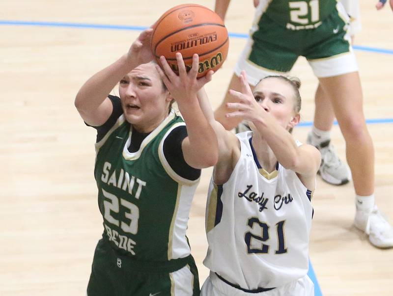 St. Bede's Ali Bosnich grabs a rebound over Marquette's Avery Durdan on Monday, Nov. 27, 2023 in Bader Gym at Marquette High School.