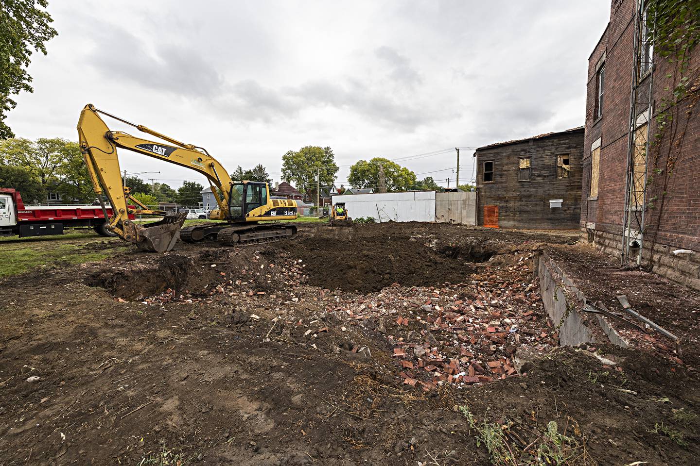 Patrick Burke of Burke Excavating fills in the basement of a second building he’s taken down at the site of a July fire Thursday, Sept. 21, 2023.