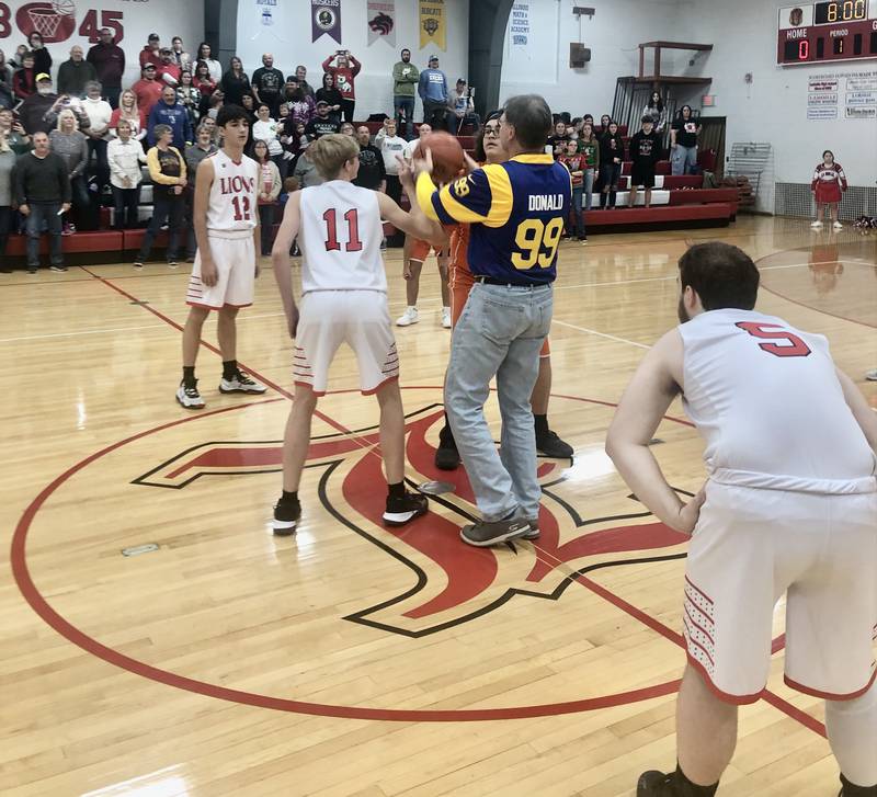 Brian Blumhorst, father of LaMoille coach Chance Blumhorst and DePue coach Trae Blumhorst, tosses a ceremonial jump ball before Friday's game in LaMoille.