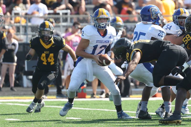 Joliet Central’s Paul Slick takes the snap against Joliet West on Saturday, Sept. 23, 2023 in Joliet.