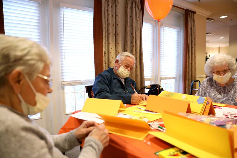 Brighton Gardens of St. Charles resident Joe Diorio (center), with Anne Stagno (left) and Geri Butcher (right), creates kindness table signs for Lazarus House shelter, St. Charles Public Library and River Crossing senior living facility as part of the sixth annual Random Acts of Kindness Week sponsored by Random Acts Matter, a volunteer organization committed to sharing care and compassion in St. Charles.