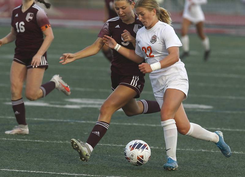 Crystal Lake Central's Olivia Anderson pushes the ball up the field agains St. Ignatius College Prep's Isabelle Radecki during the Class 2A Deerfield Supersectional girls soccer match on Tuesday, May 28, 2024, at Deerfield High School.