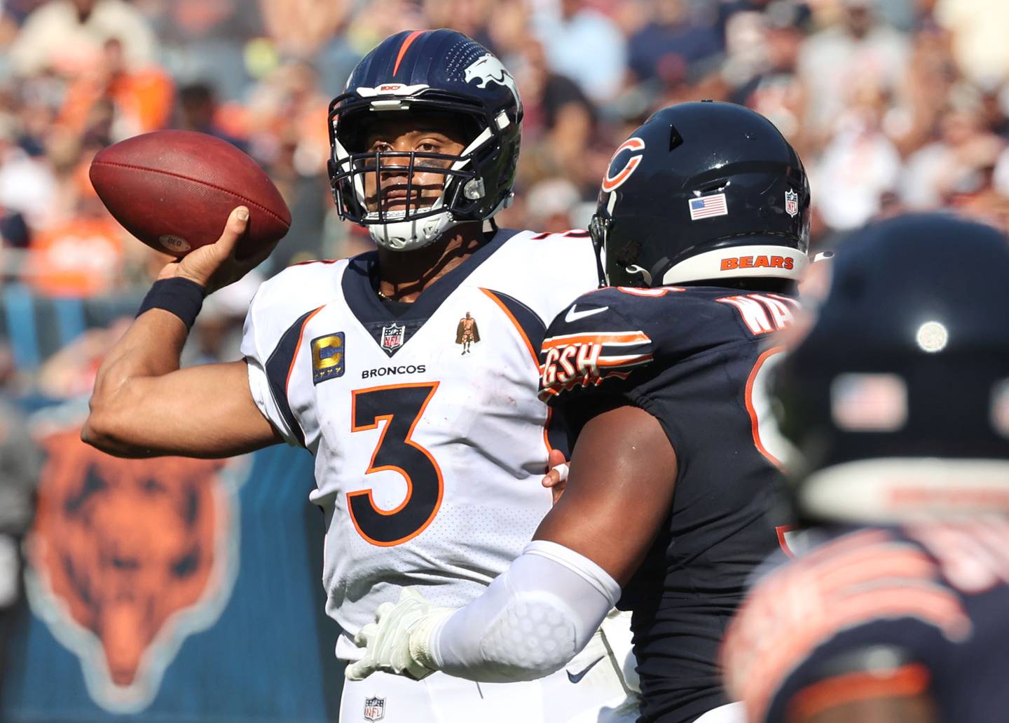 Denver Broncos quarterback Russell Wilson gets the ball off just ahead of the pressure of Chicago Bears defensive end DeMarcus Walker during their game Sunday, Oct. 1, 2023, at Soldier Field in Chicago.
