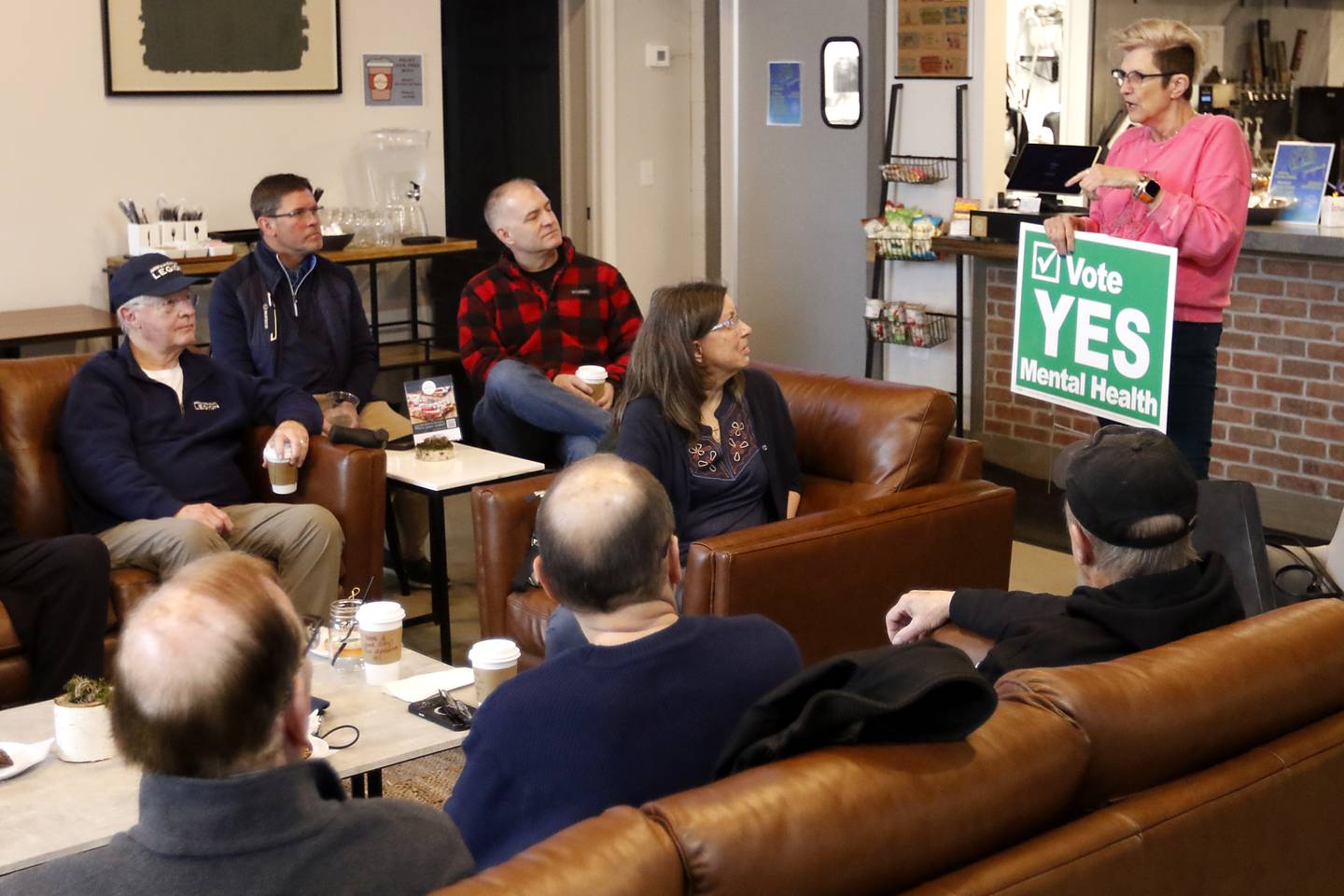 Donna Rasmussen talks with other veterans on about voting on raising the sales tax to fund mental health on Friday, March 8, 2024, at the Other Side in Crystal Lake, during a meeting of area veterans.