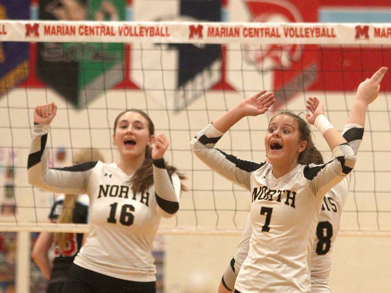 Grayslake North’s Hailey Ryan, left, and Reese Oatsvall celebrate a point in girls volleyball at Marian Central in Woodstock Monday.