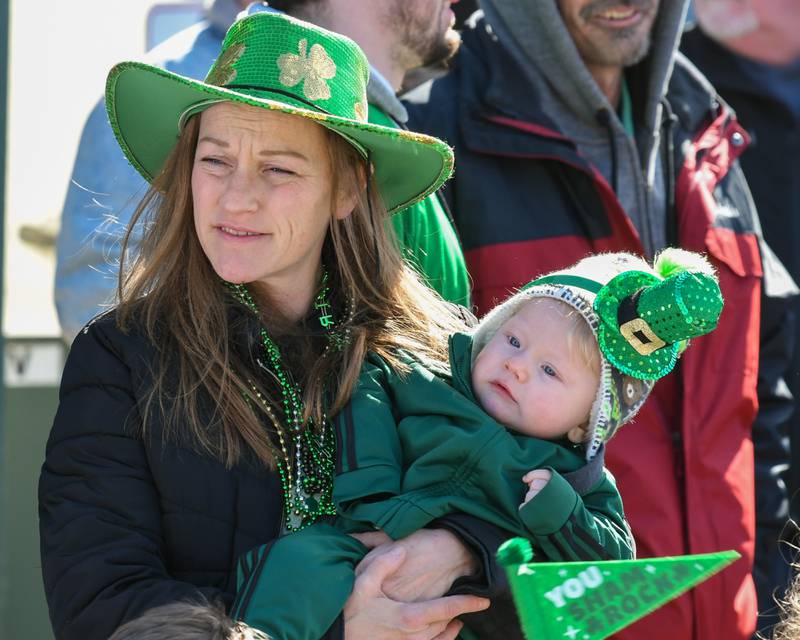 Debbie Ignoffo of Justice and 9 month old son Nico watch the St. Patrick’s parade in downtown Lemont on Saturday March 9, 2024.