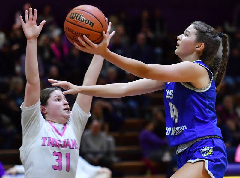 Emma O'Brien (right) takse the ball to the basket as Downers Grove North's Ann Stephens (31) defends during a game on Jan. 30, 2024 at Downers Grove North High School in Downers Grove .