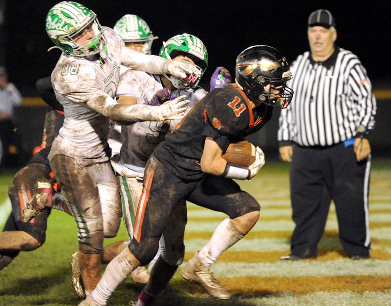 Sandwich running back Nick Mihalek (11) avoids the grasps of several Ridgewood defenders to score a touchdown during a varsity football game at Sandwich High School on Friday, Oct. 27, 2023.