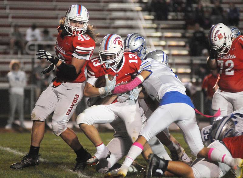 Ottawa's Ryder Miller (13) pushes through the tackle of Woodstock's Caden Mont at King Field on Friday, Oct. 21, 2022.