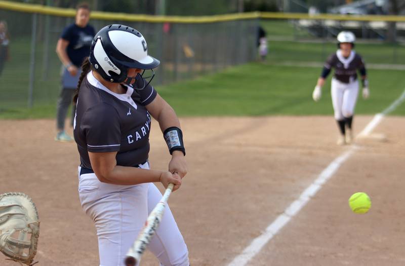 Cary-Grove’s Addison DeSomer connects for a home run against Burlington Central in varsity softball at Cary Monday.