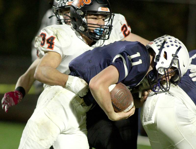 Cary-Grove’s Peyton Seaburg runs the ball against Libertyville  in first-round Class 6A playoff  football action at Cary Friday.