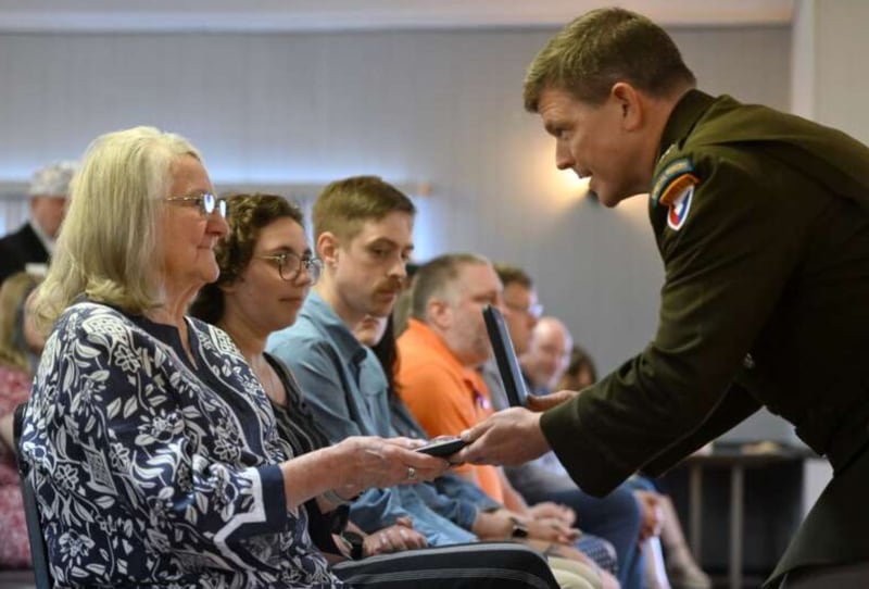 Anna Green Showerman of Batavia receives the Bronze Star from Army Col. Daniel Mitchell following a ceremony Tuesday, June 25, 2024, in Batavia. Showerman's father, Army Staff Sgt. John W. Green, earned the medal while serving and dying in action during World War II.