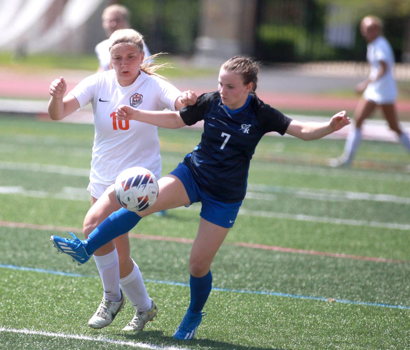 Crystal Lake Central’s Brooklynn Carlson (left) and Burlington Central’s Lily Batani go after the ball during the Class 2A state semifinal game at North Central College in Naperville on Friday, May 31, 2024.