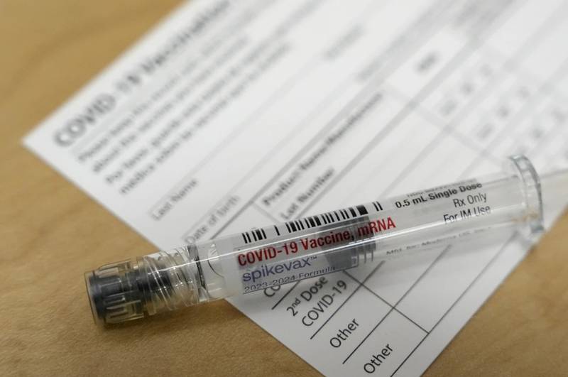 A Moderna Spikevax COVID-19 vaccine is seen at a pharmacy. Vaccination season is in full swing, with health officials in the United States urging both an updated COVID-19 shot and flu vaccine for most everyone. New this year are vaccines for older adults and women in late pregnancy to guard against another virus named RSV.