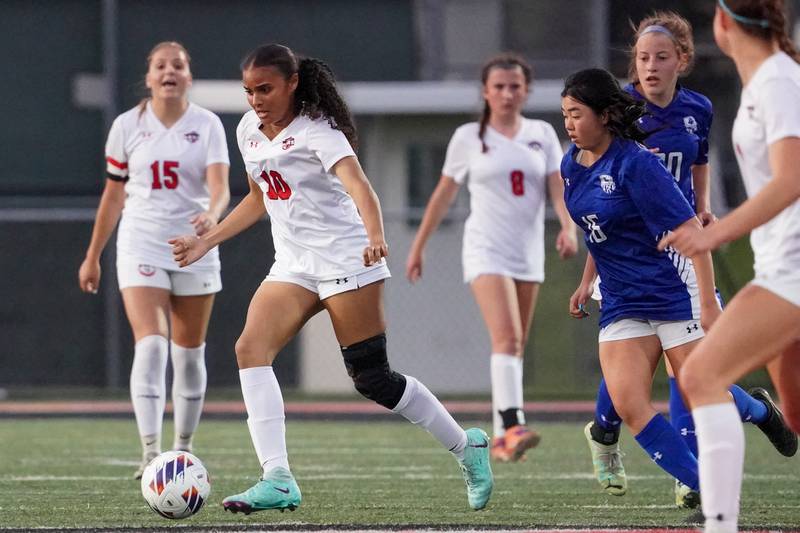 Glenbard East's Jazzlyn Hamilton (10) plays the ball against Geneva’s Leyna Yonehara (16) during a Class 3A Glenbard East Regional semifinal soccer match at Glenbard East High School in Lombard on Tuesday, May 14, 2024.