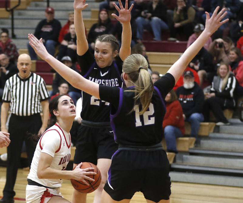 Huntley's Jessica Ozzauto shoots the ball between Hampshire's Whitney Thompson and Kaitlyn Milison during a Fox Valley Conference girls basketball game Monday, Jan. 30, 2023, at Huntley High School.