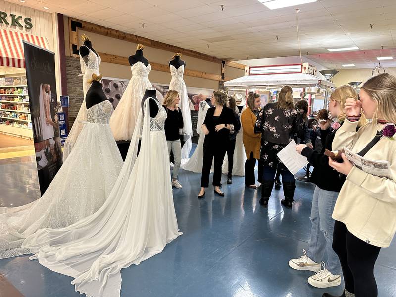 Sauk Valley Wedding Expo attendees view the Savy's Chic Bridal Boutique display at the 2023 expo.