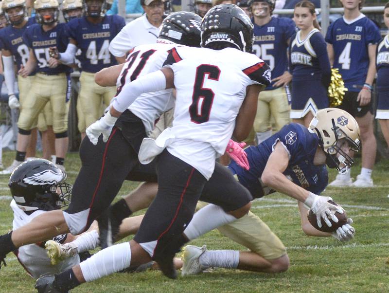 Marquette’s Billy Galyen reaches for a 1st down on a run in the 1st quarter Friday at Marquette.