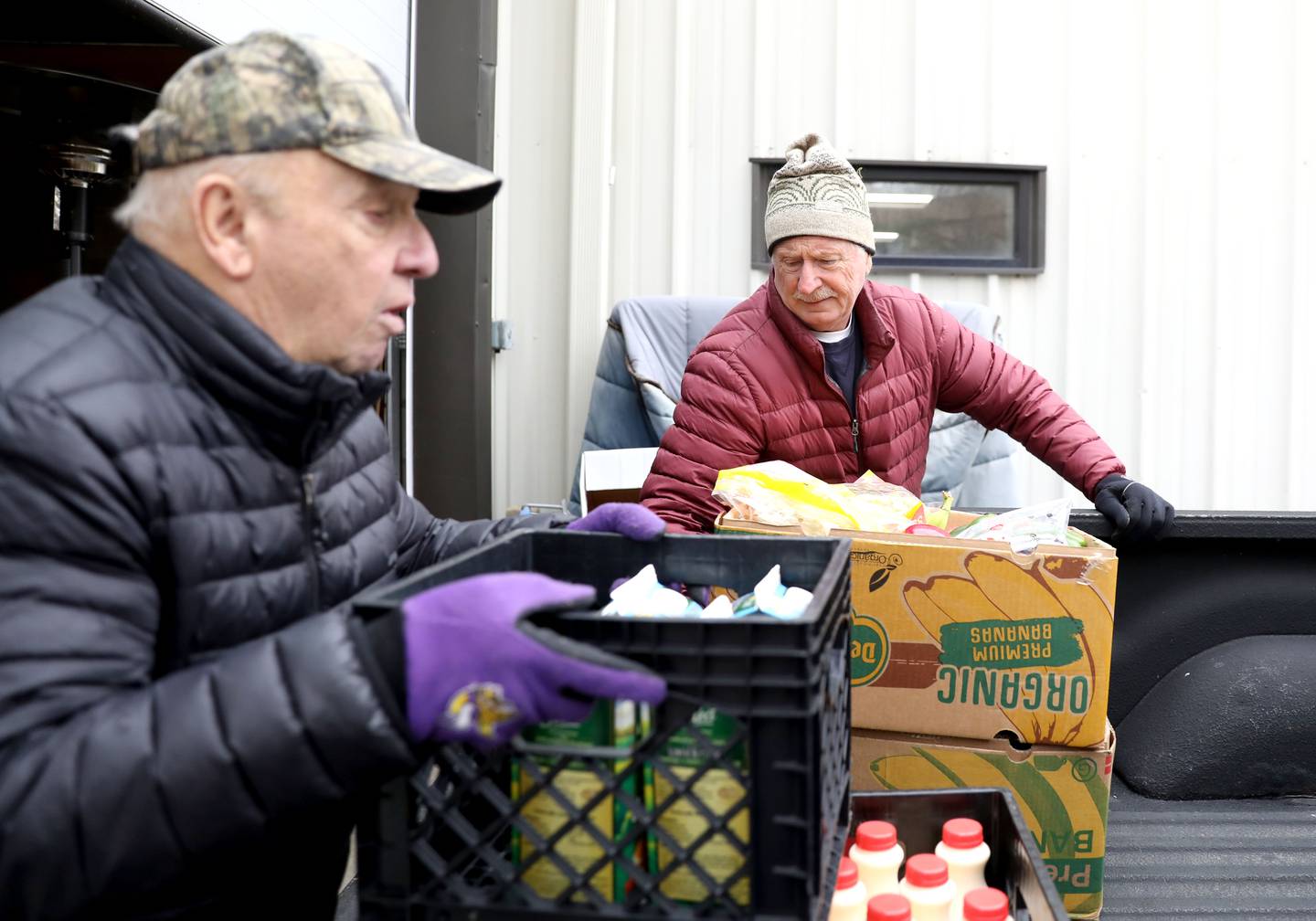 Volunteers Don Flynn (left) and Mike Chmelik unload donations from Jewel-Osco in Sugar Grove at the Between Friends Food Pantry of Sugar Grove.