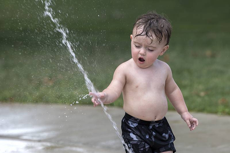 Odin Miller, 2, explores a stream of water Thursday, June 20, 2024 at Grandon Park in Sterling. Miller was there with mom Alexandra Gonzalez and grandpa Lou Gonzalez.